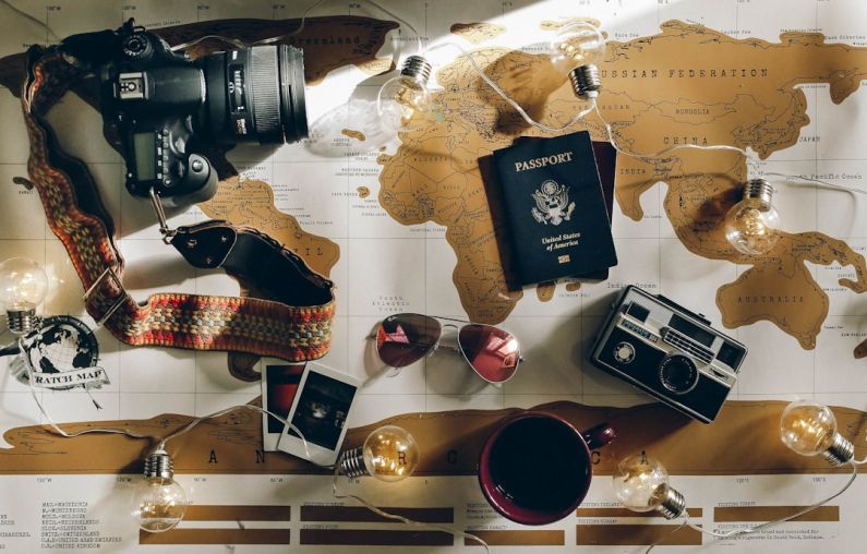 Travel Accessories - black DSLR camera near passport