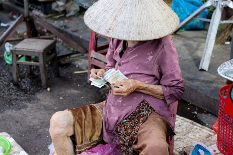 Cultural Crafts - a woman sitting on the ground with a hat on her head